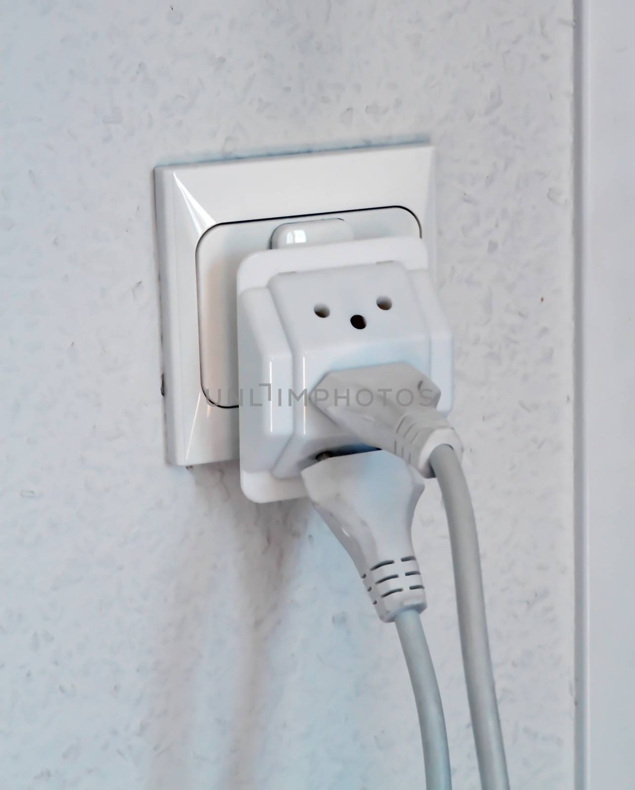 Multiple electrical plugs in wall outlet, Switzerland, Europe