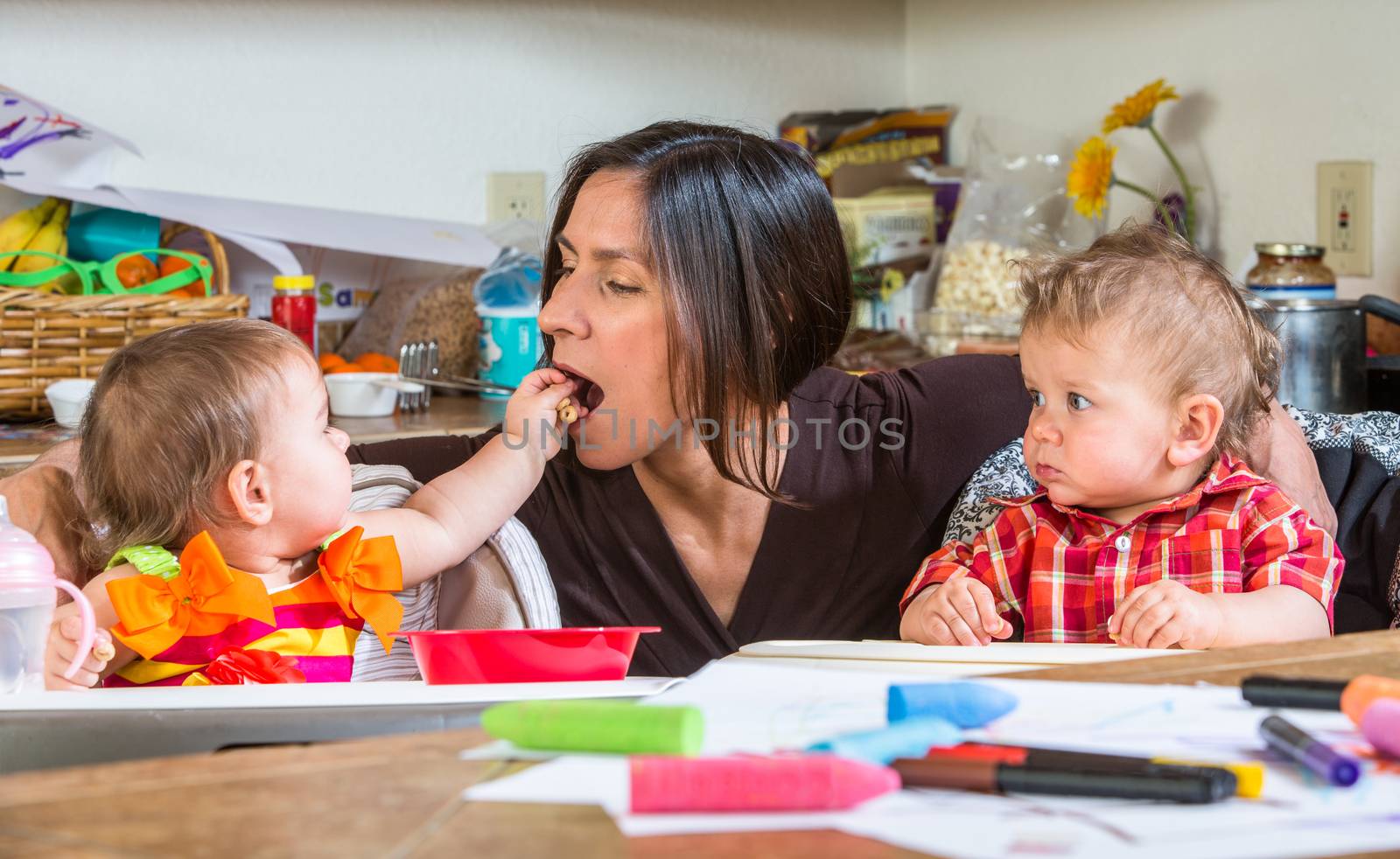 A Baby feeds her mother at breakfast