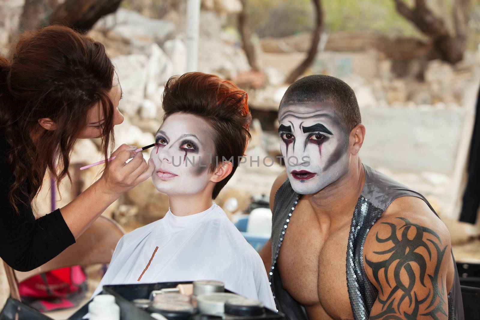 Makeup artist working clown eyeliner for performers