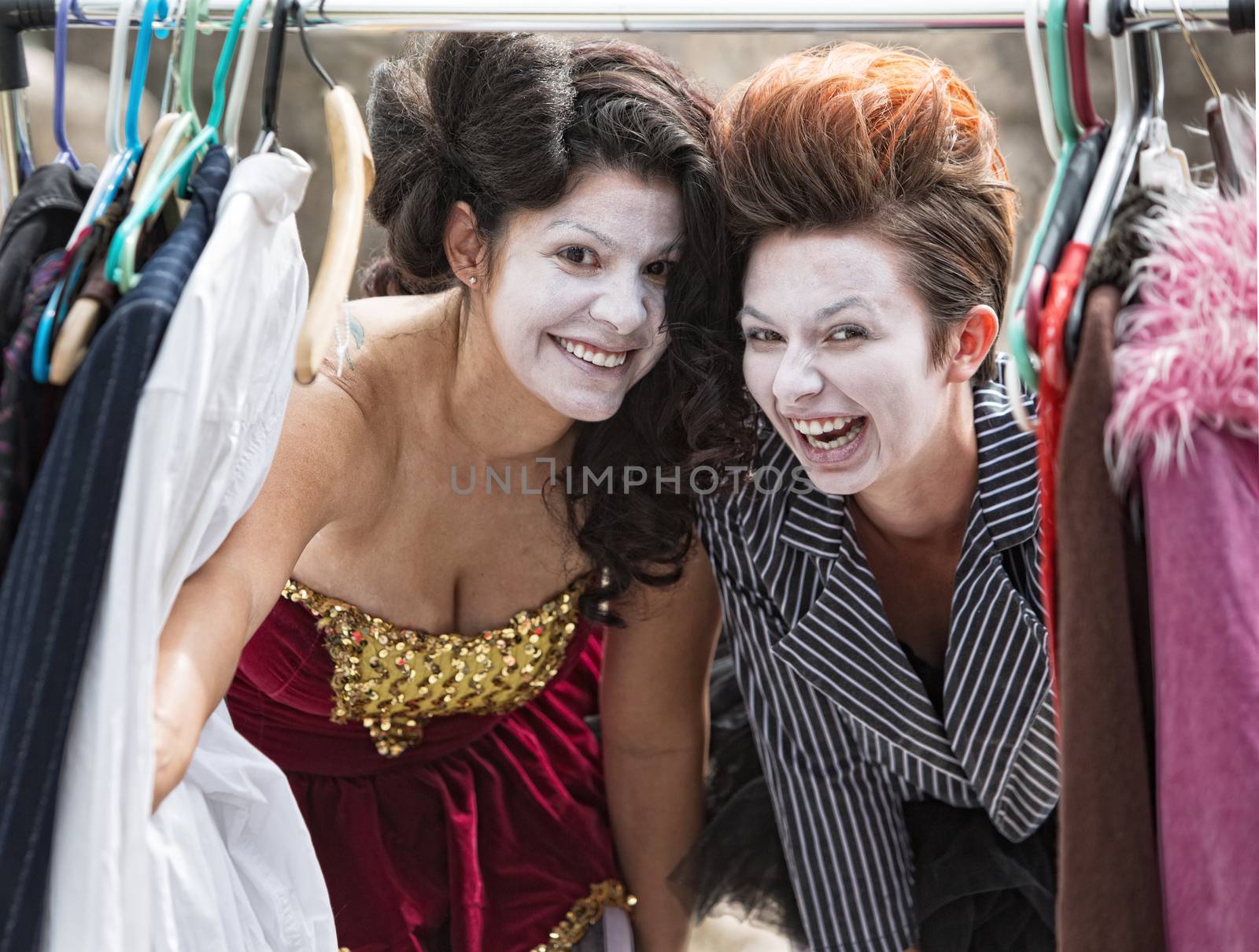 Comedia Del Arte actors laughing at clothing rack
