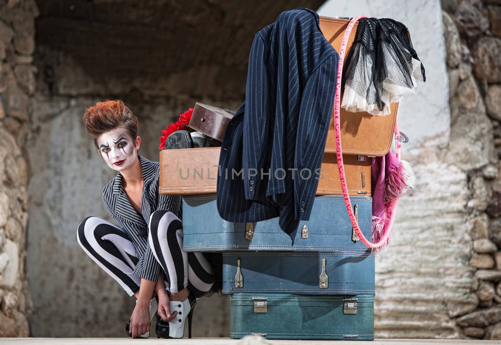 Grinning Clown Near Suitcases by Creatista