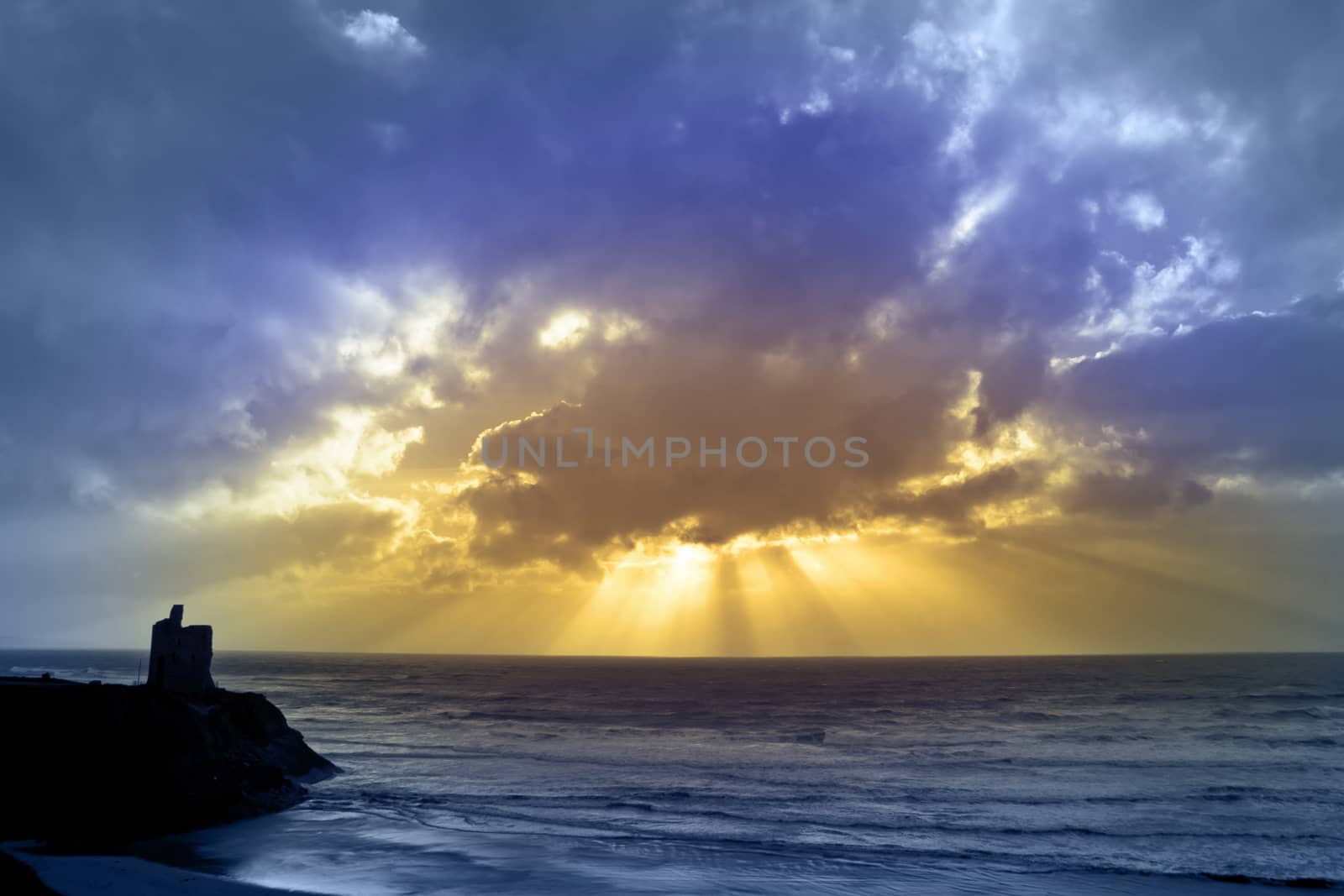 castle in Ballybunion county Kerry Ireland with beautiful beams shining through the clouds