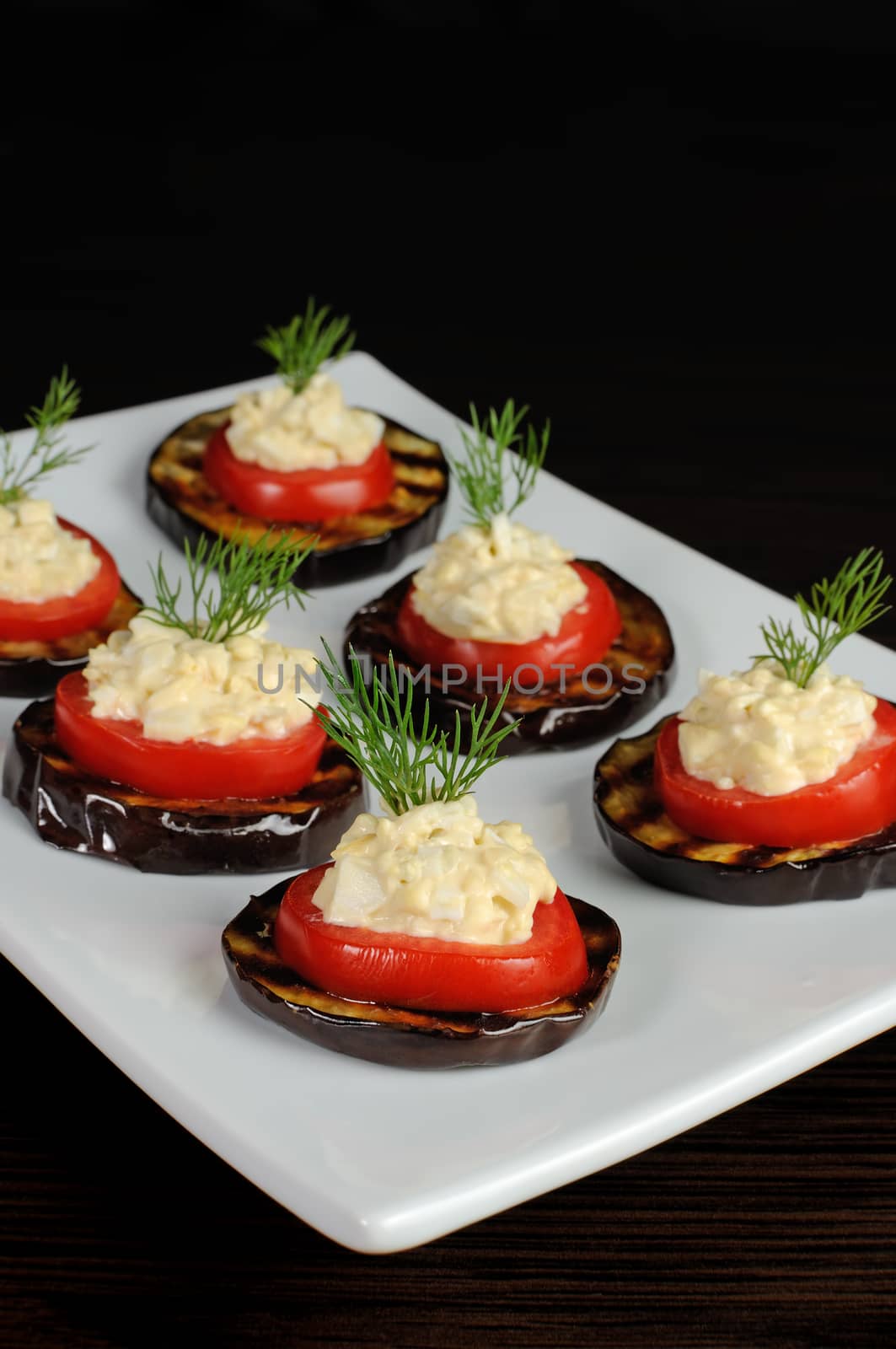 appetizer of grilled eggplant with tomato and spicy stuffing