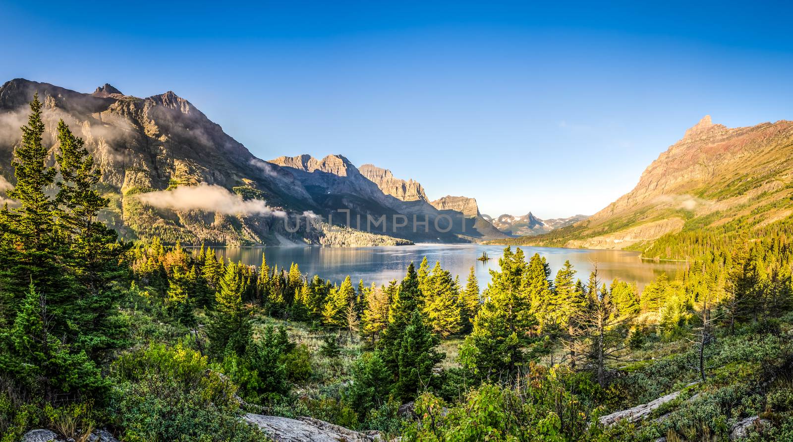 Panoramic landscape view of Glacier NP mountain range and lake by martinm303