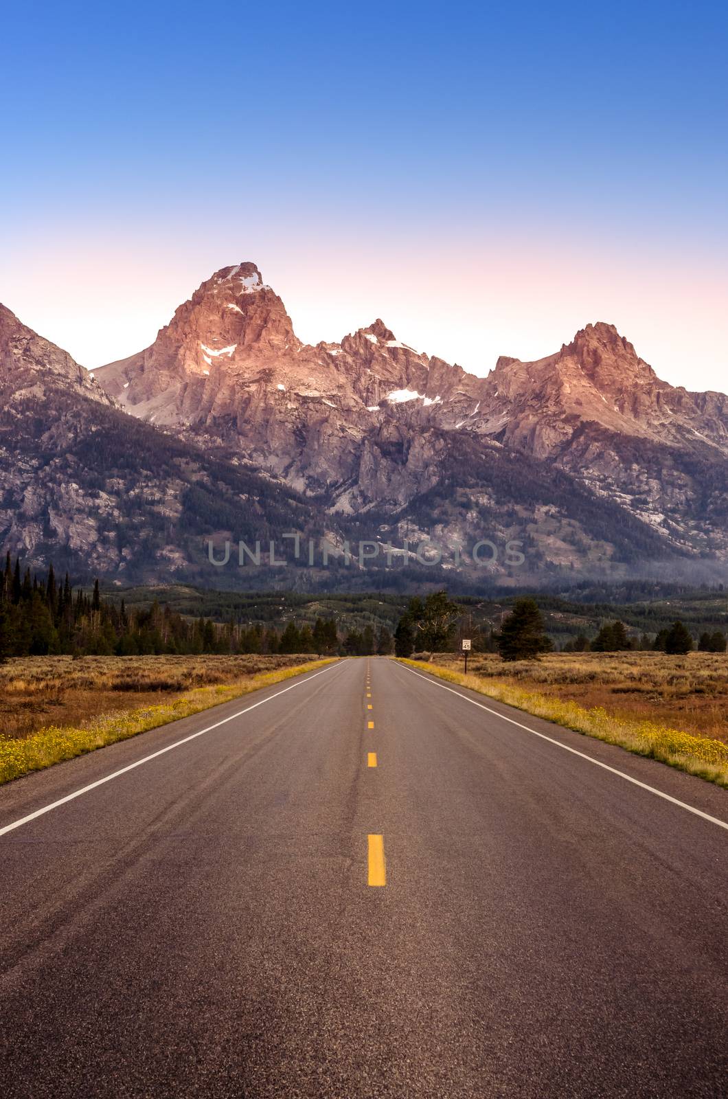 Scenic view of Grand Teton mountain range and road, Wyoming, USA