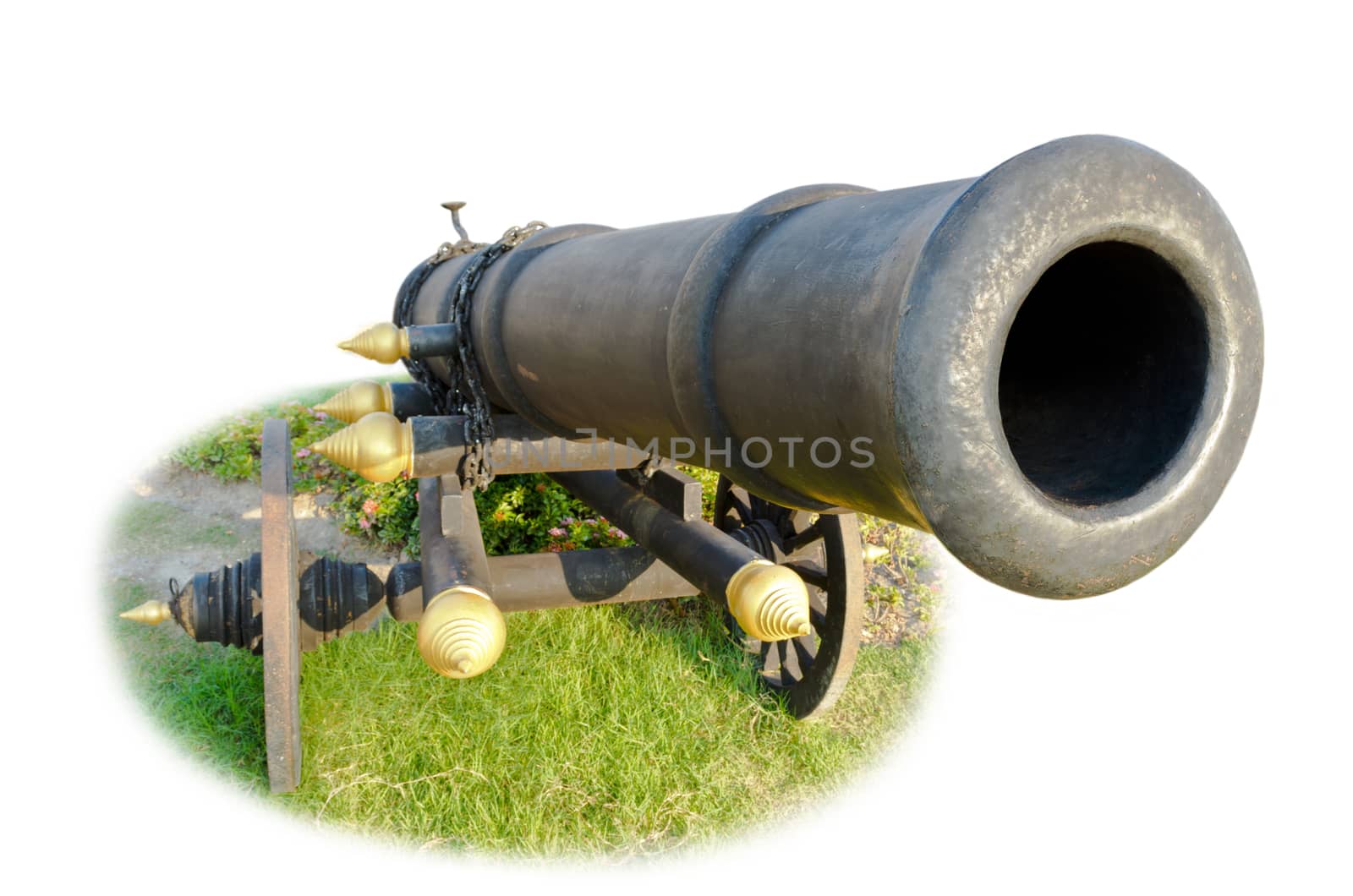 Cannon on wheels moving in grass. Thailand's ancient weapons on white background