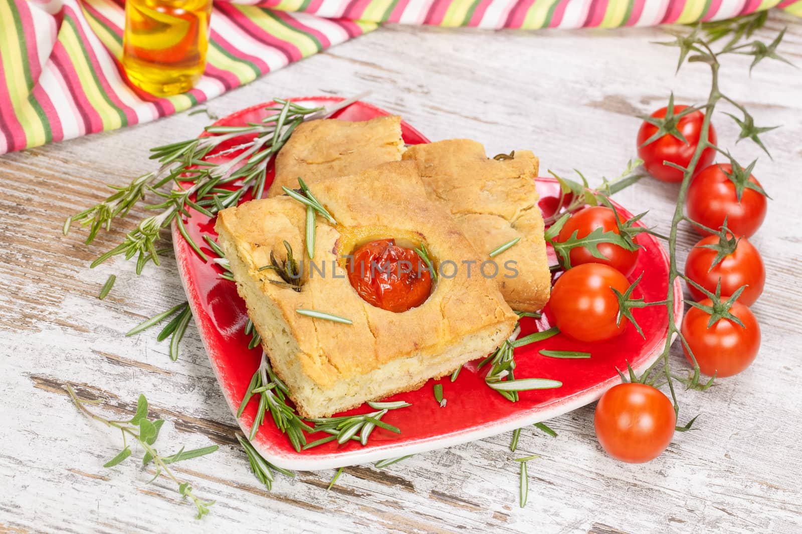 Focaccia italian bread slices with tomato and rosemary.