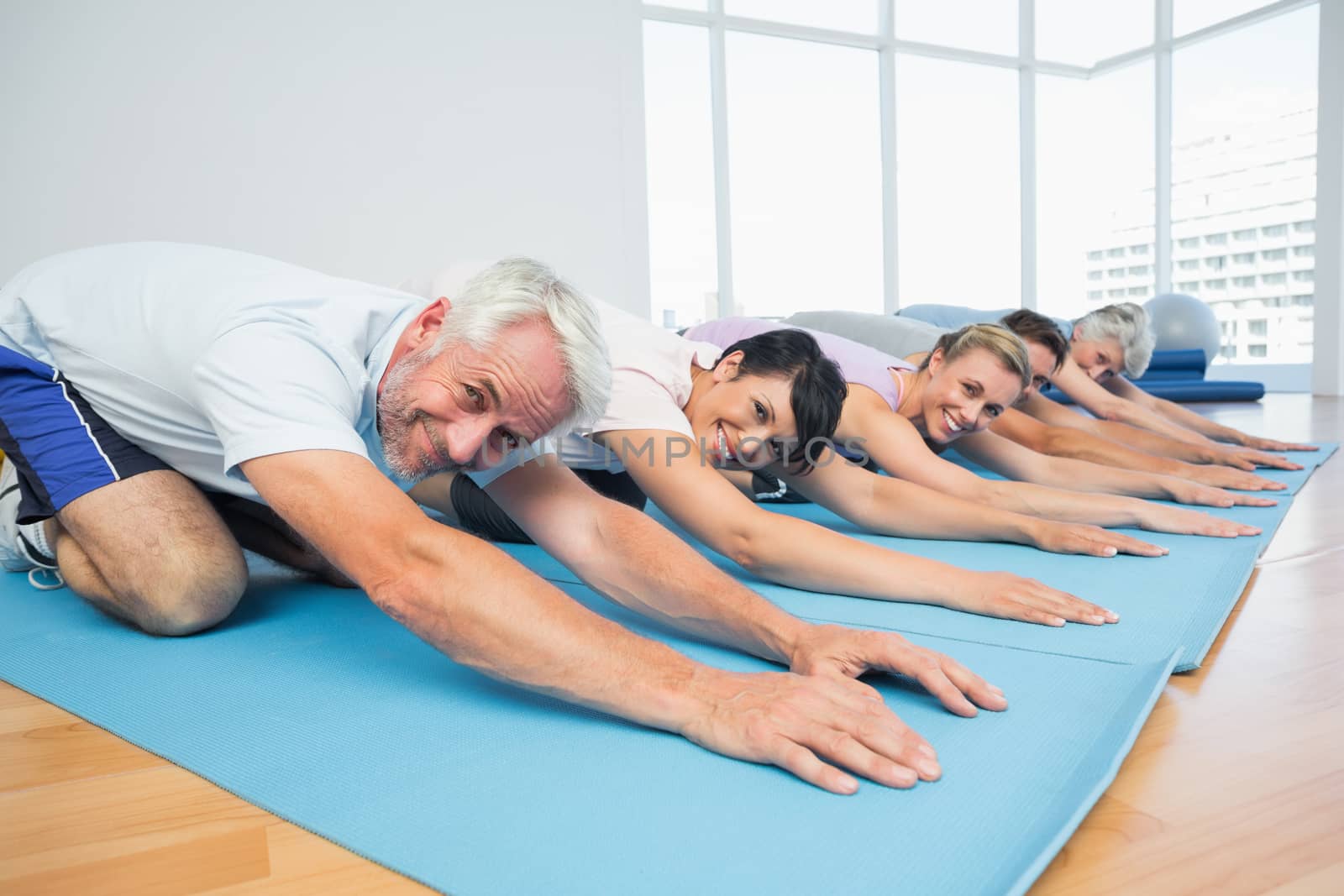 Portrait of fitness group bowing in row by Wavebreakmedia