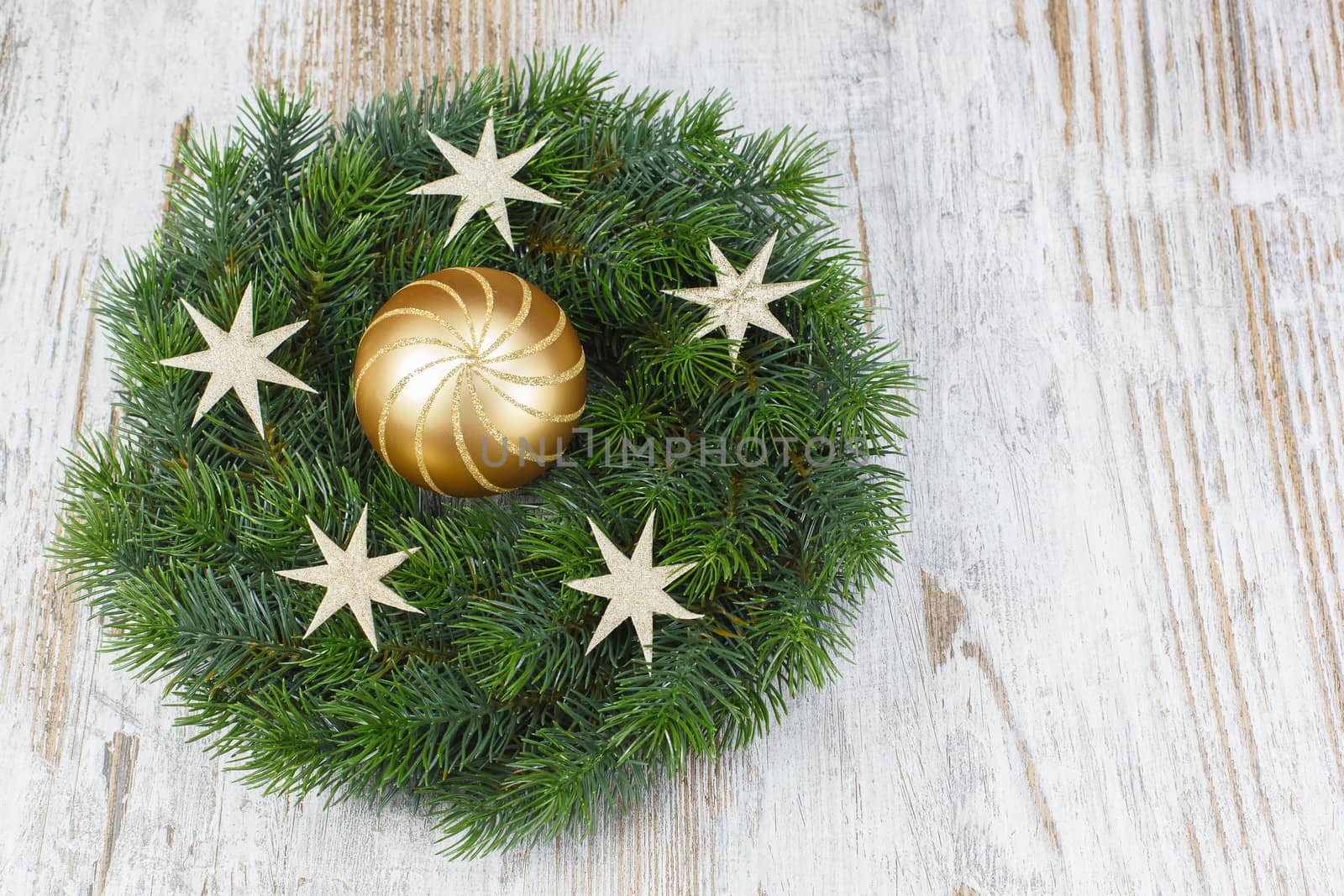 Christmas wreath with bauble on the old wooden background. Copy space composition