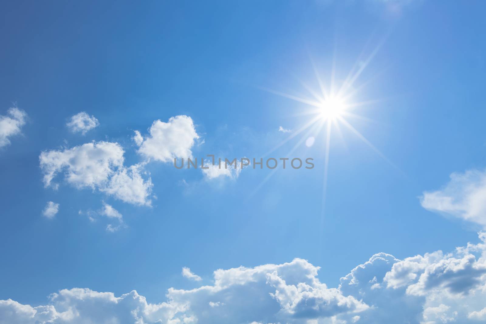Blue sky with clouds and sun ray