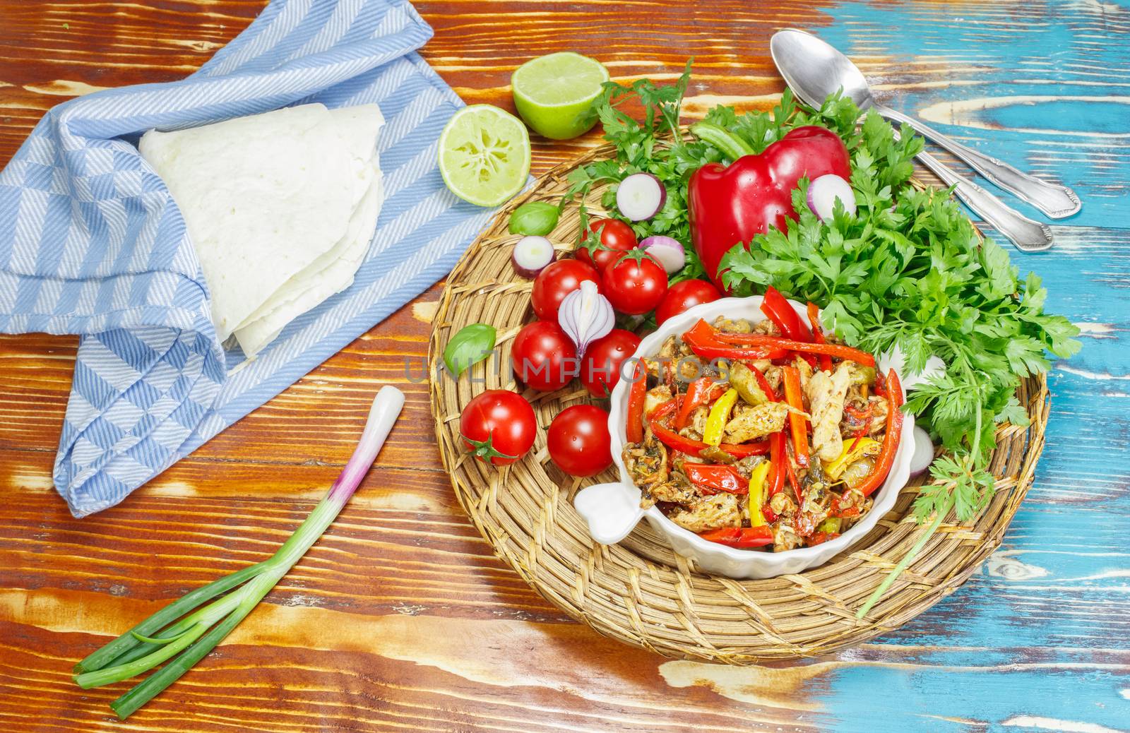 Strips of grilled chicken breast with sauteed peppers and onions, served with flour tortillas and salsa