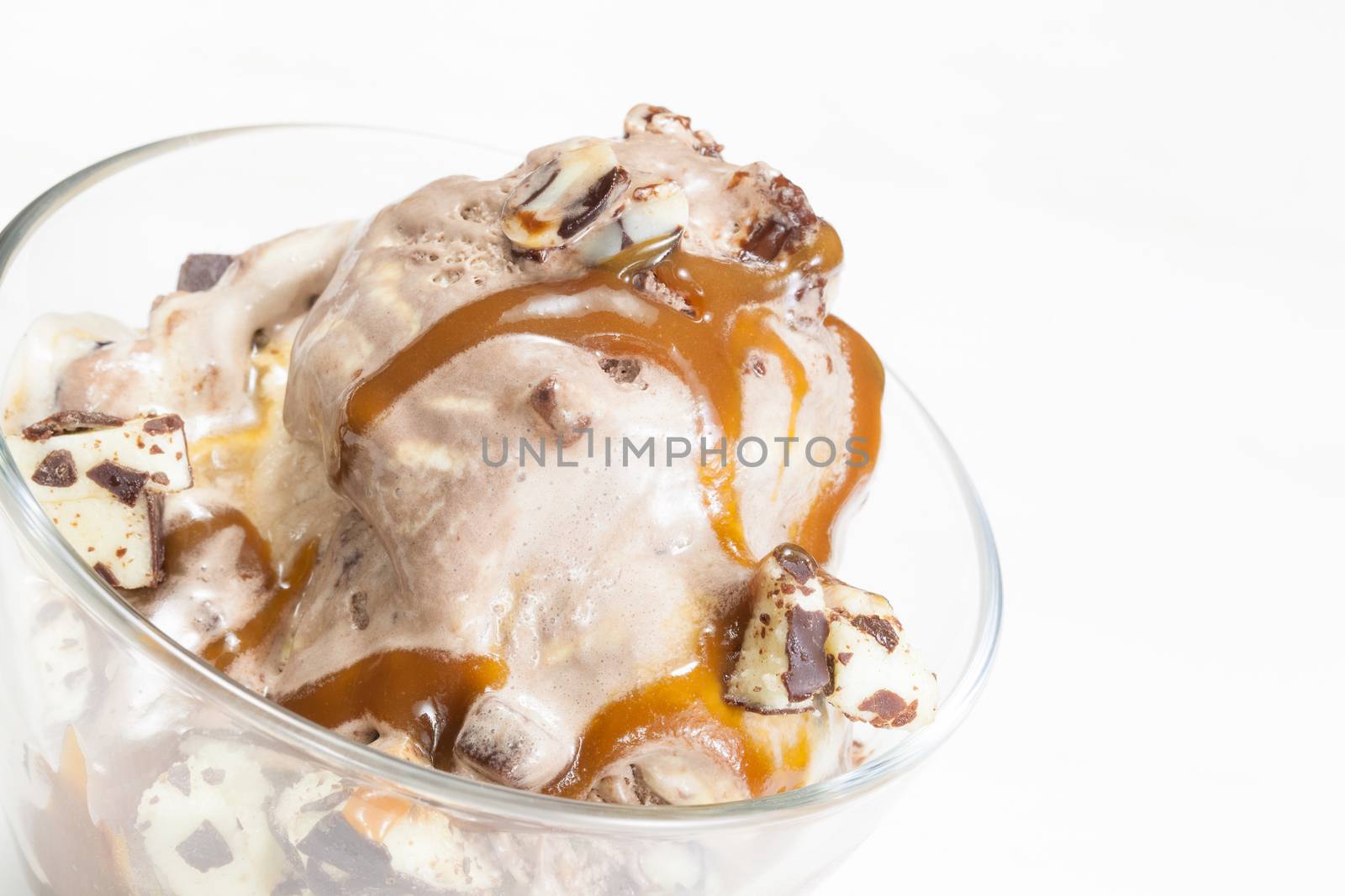 Ice Cream Sundae topped with caramel syrup and chocolate truffle. Close up.