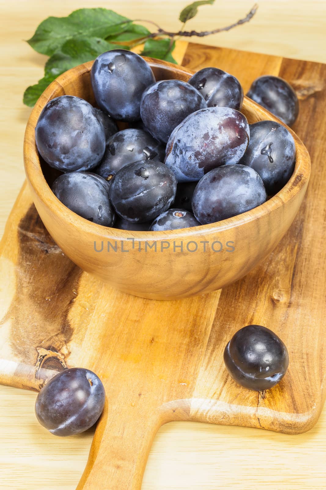 Fresh plums on wooden table