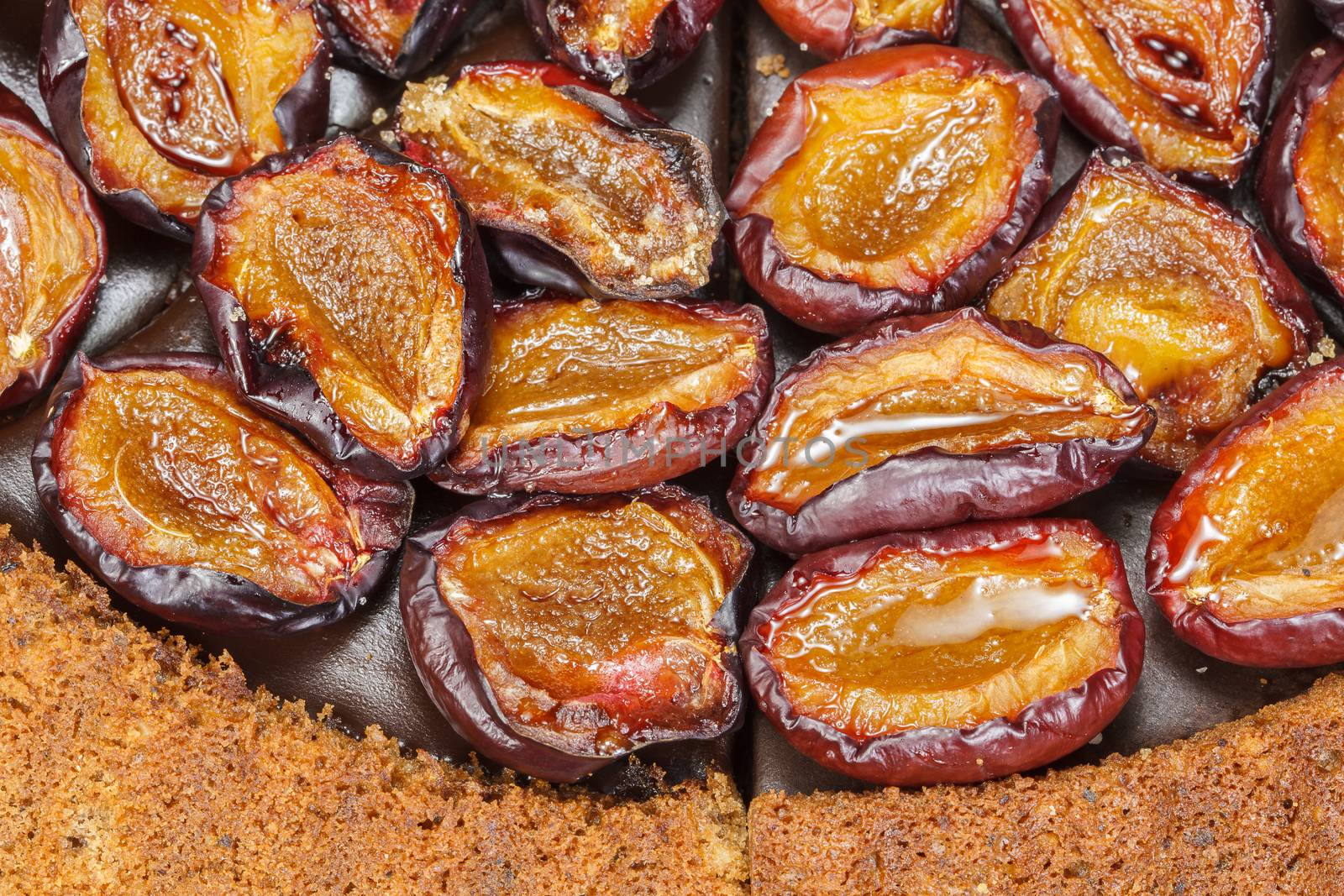 Plum cake with roasted cinnamon plums. Close up, macro. Above view