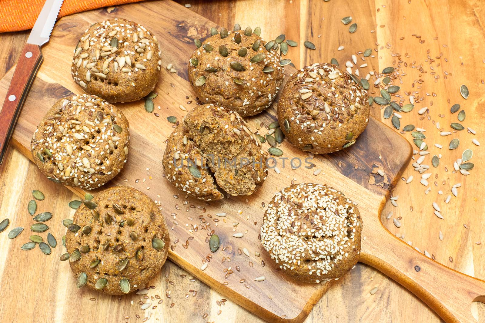 Freshly baked whole grain bread rolls on wooden background. Copy space. Viewed from above