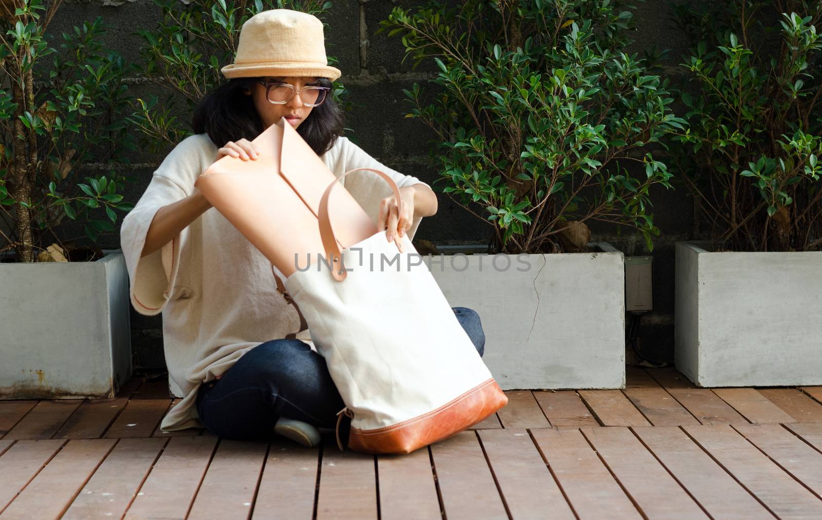 Young woman finding something in a canvas bag