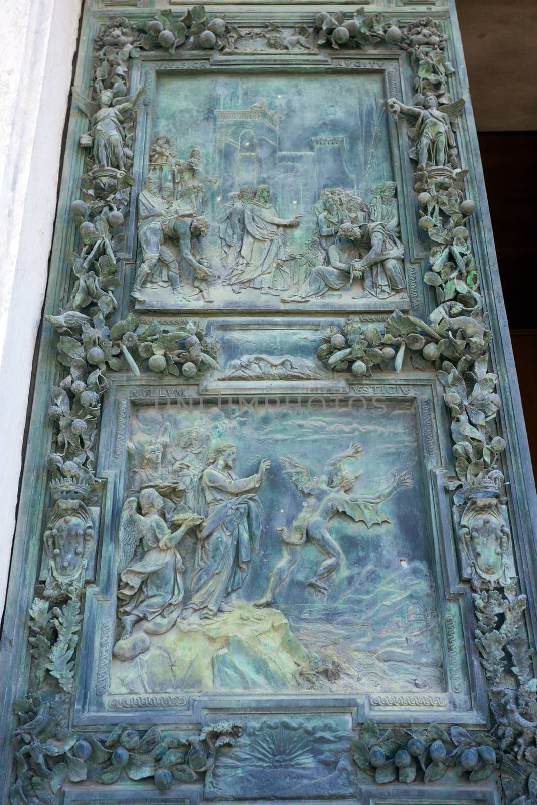 PISA, ITALY - AUGUST 11, 2013: Battistero Pisa entrance bronze gate detail, Piazza del Duomo, Italy
