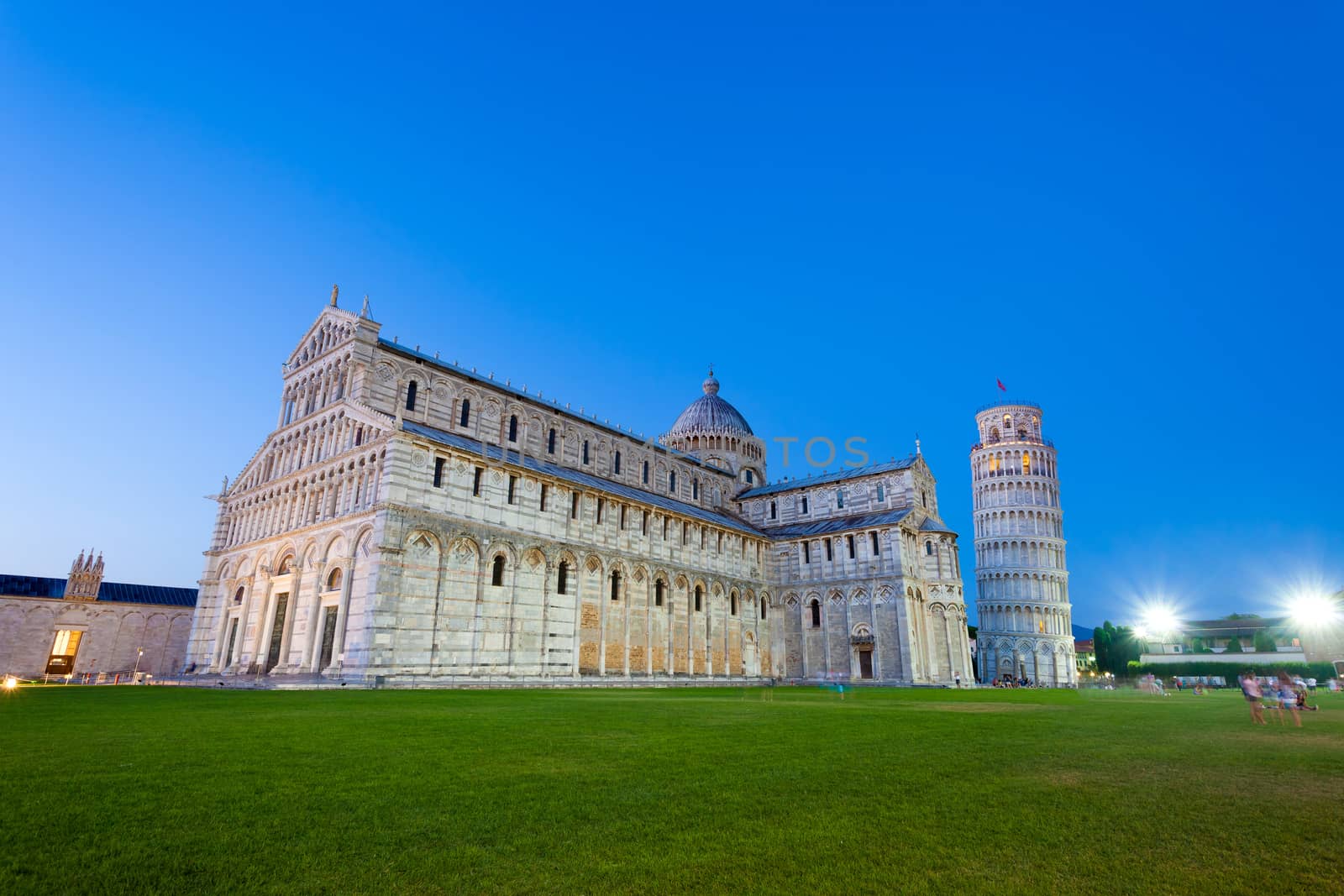 Pisa, Italy - August 11, 2013: Piazza del Duomo with Pisa tower and the Cathedral illuminated at night, Pisa, Italy