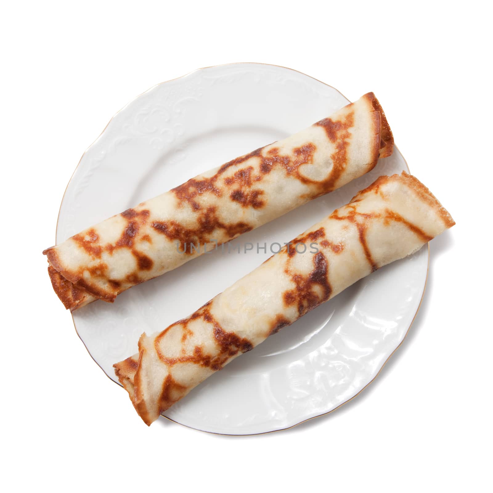Two rolled pancakes on a plate isolated over white