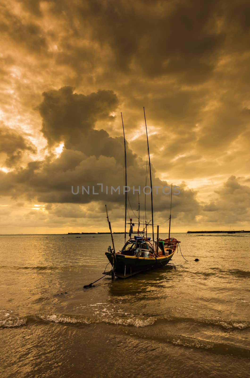 Fishing sea boat and Sunrise clouds before strom in Thailand gold light tone