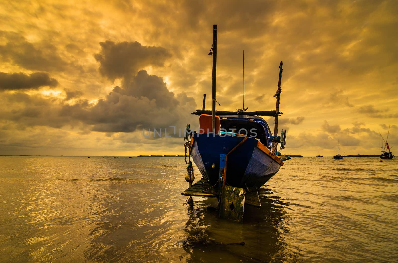 Fishing sea boat and Sunrise clouds before strom in Thailand gold light tone