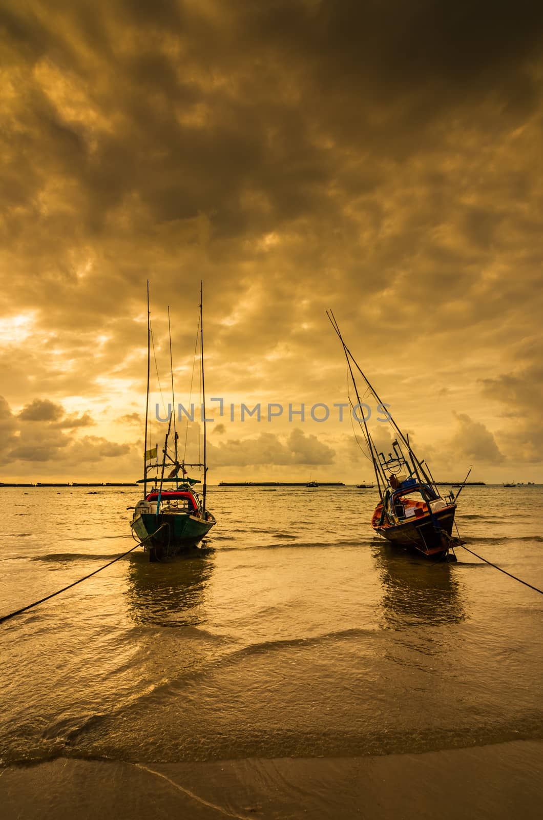 Fishing sea boat and Sunrise clouds before strom in Thailand gold light tone