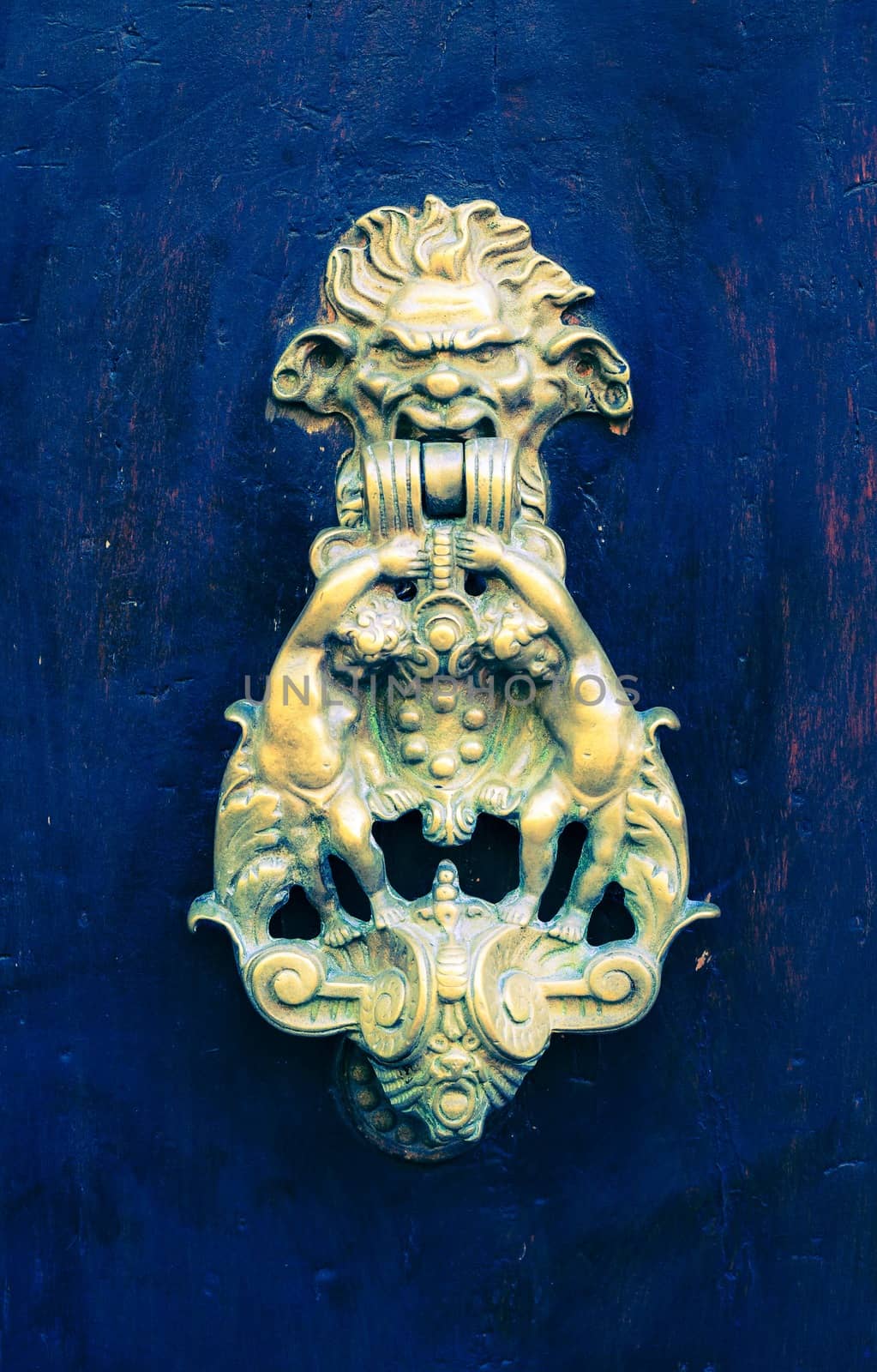 Close-up picture of a door knocker on blue background.