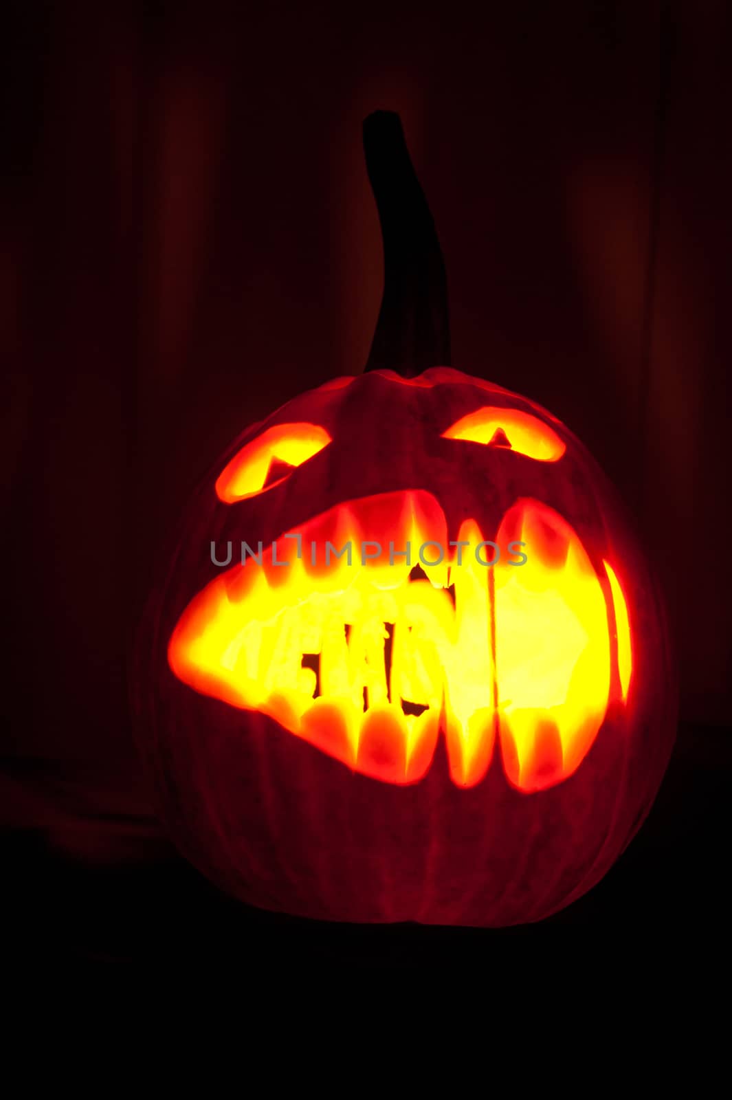 Halloween pumpkin with scary face on black backgound