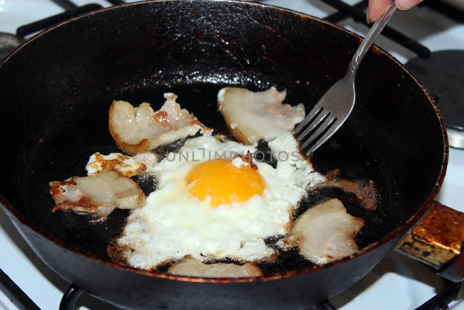 image of appetizing fried egg during cooking