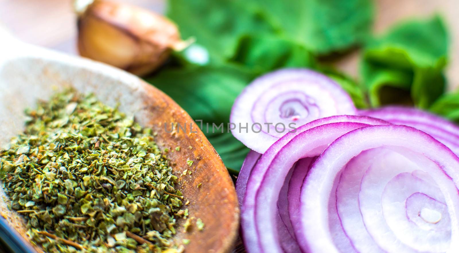 purple onion and spices on wooden table