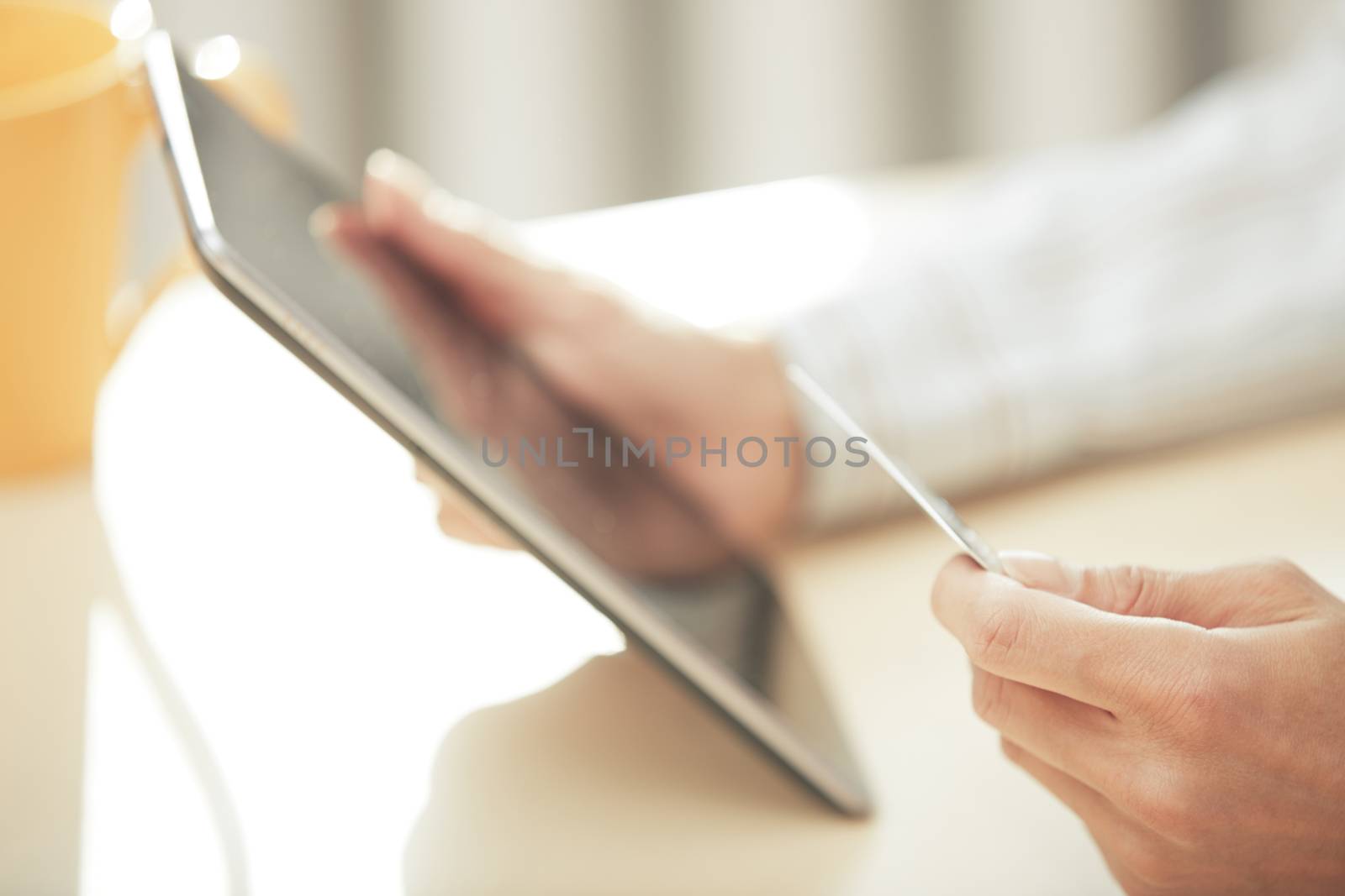 Hands of woman with credit card and digital PC