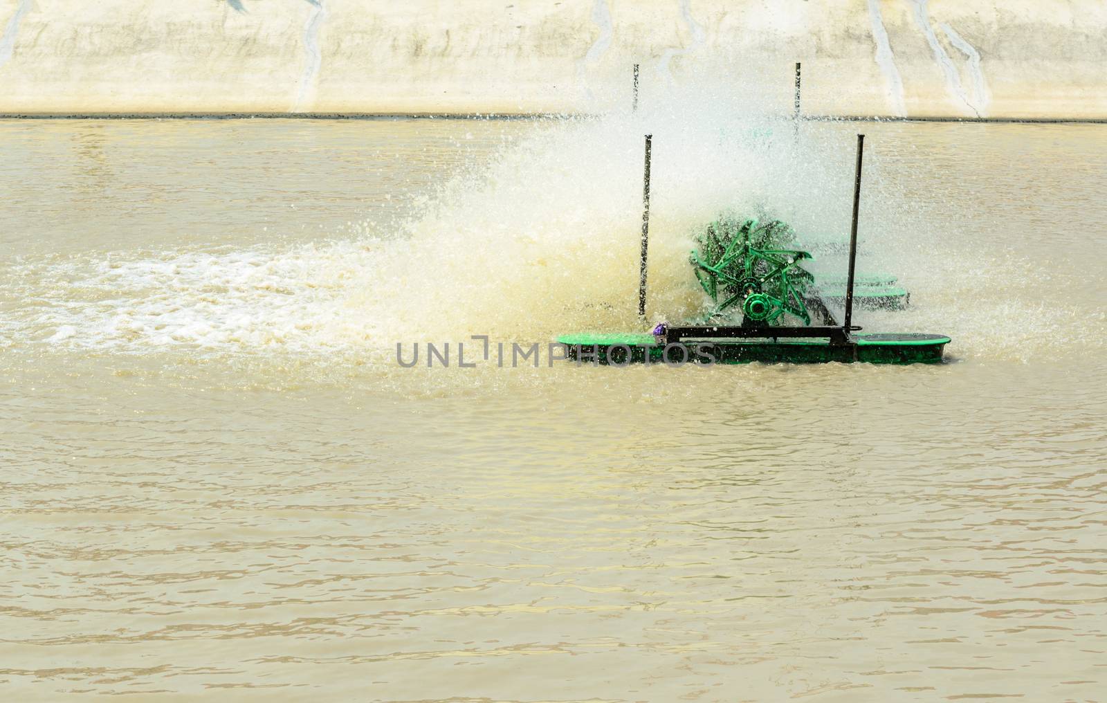 Pump adding oxygen to the water for wastewater treatment in small factories.