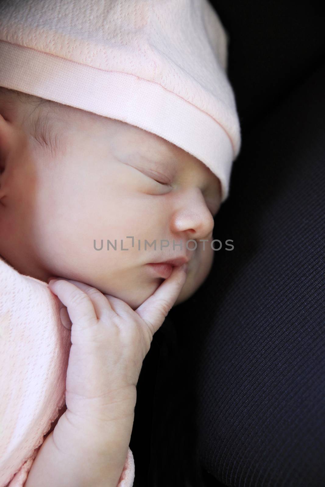 Sleeping newborn baby. The first days of life of the newborn girl