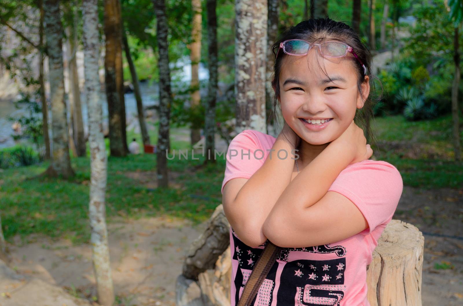 Young girl smiled happily with hiking and camping in the forest