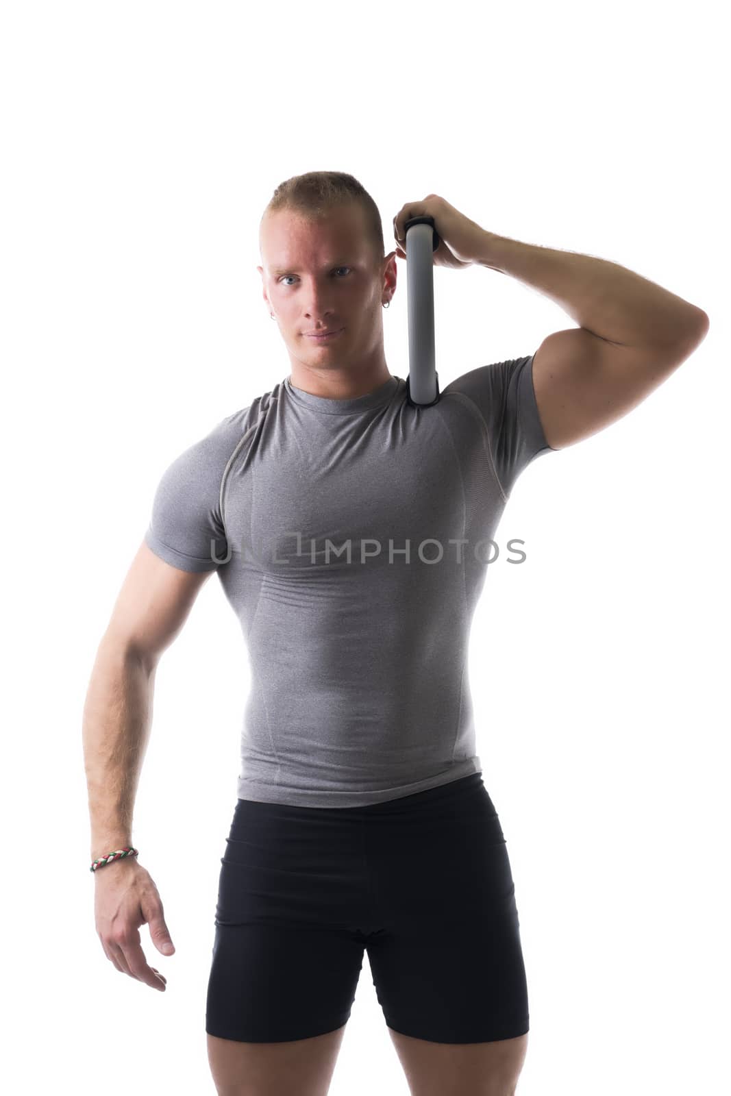 Sexy muscular man, working out with pilates ring on shoulder, isolated on white