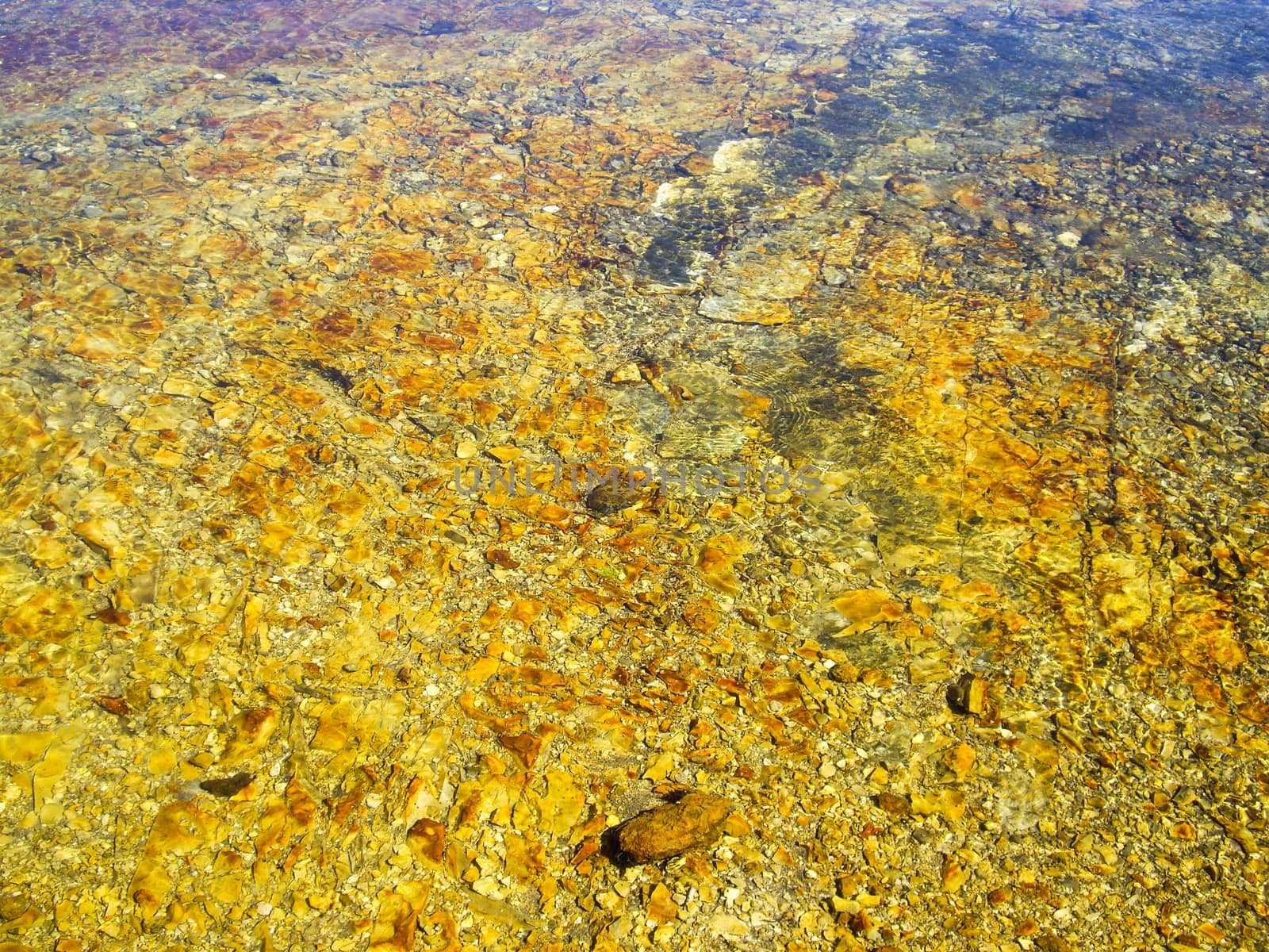 River water with yellow rocks by emattil