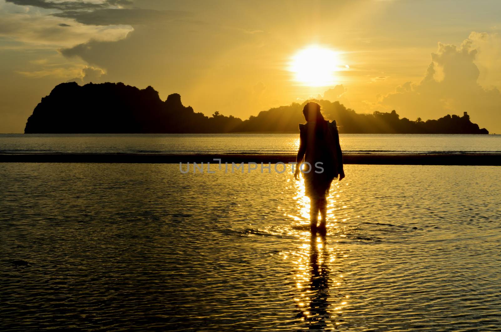 Girls on the Hat Sai Ri beach during sunrise in Chumphon Province of Thailand