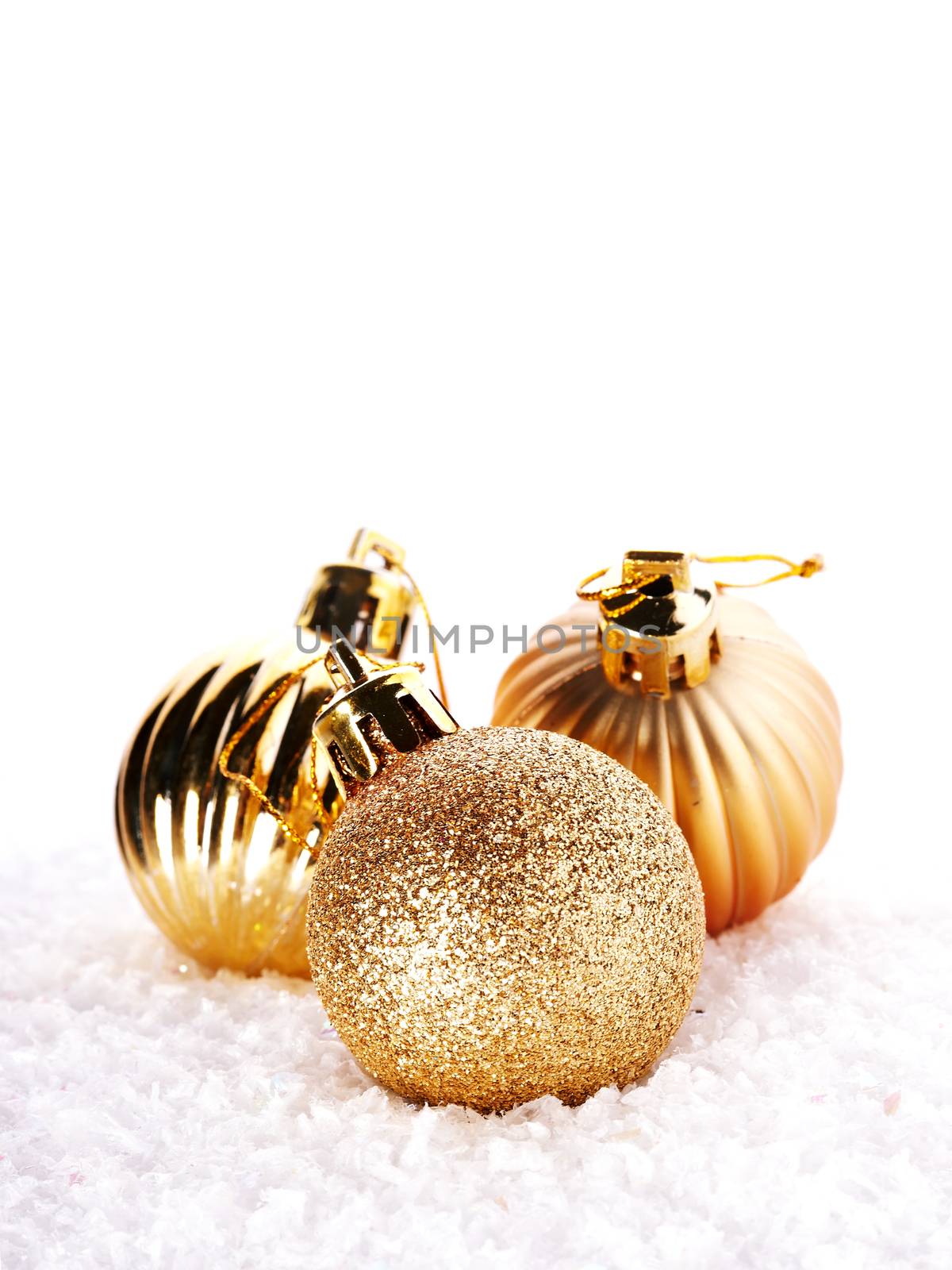 New Year's brilliant balls on snow. New Year's golden balls. Christmas balls. Christmas tree decorations. Christmas jewelry.