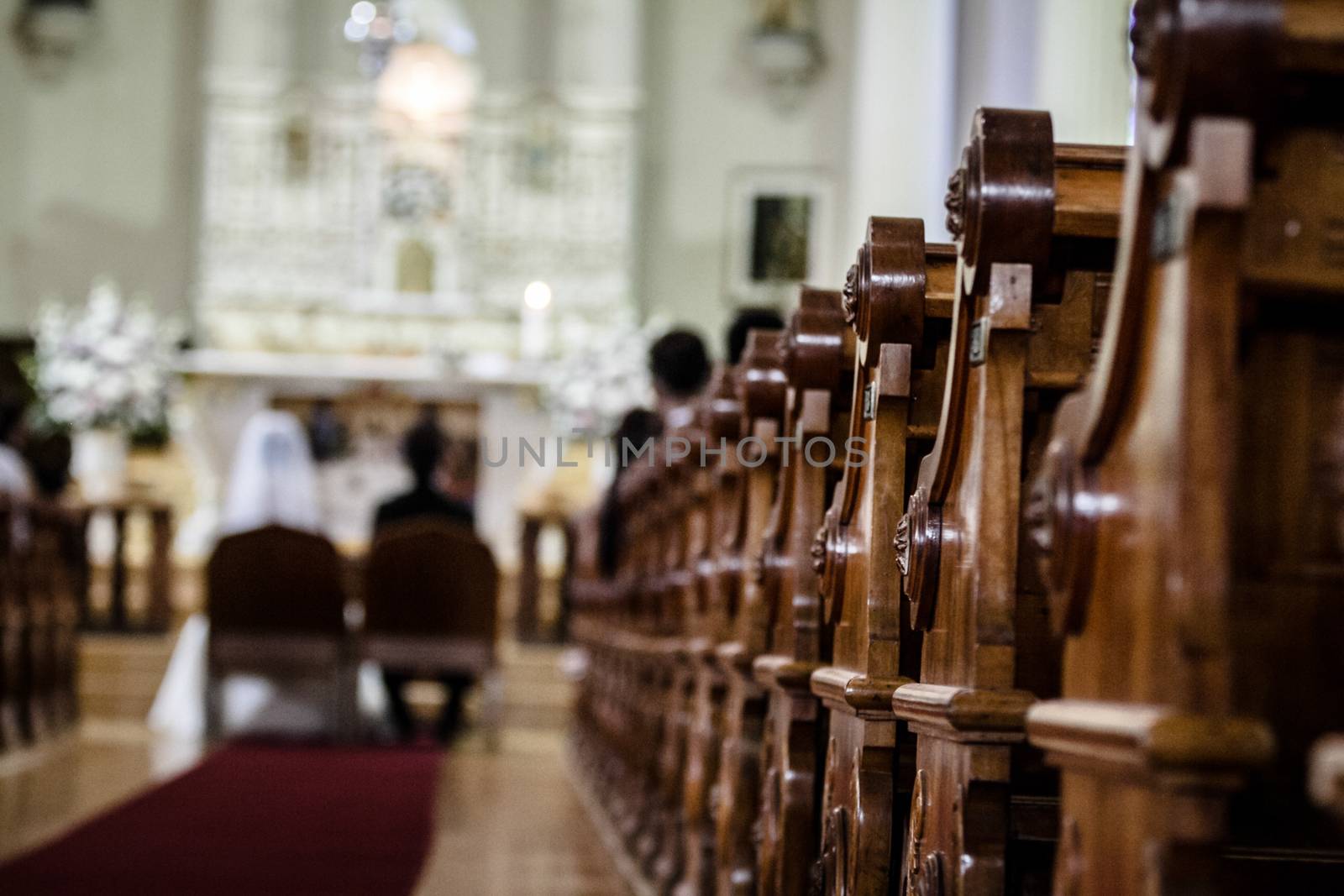 Wedding Ceremony inside a Church with Blurry Couple in Background