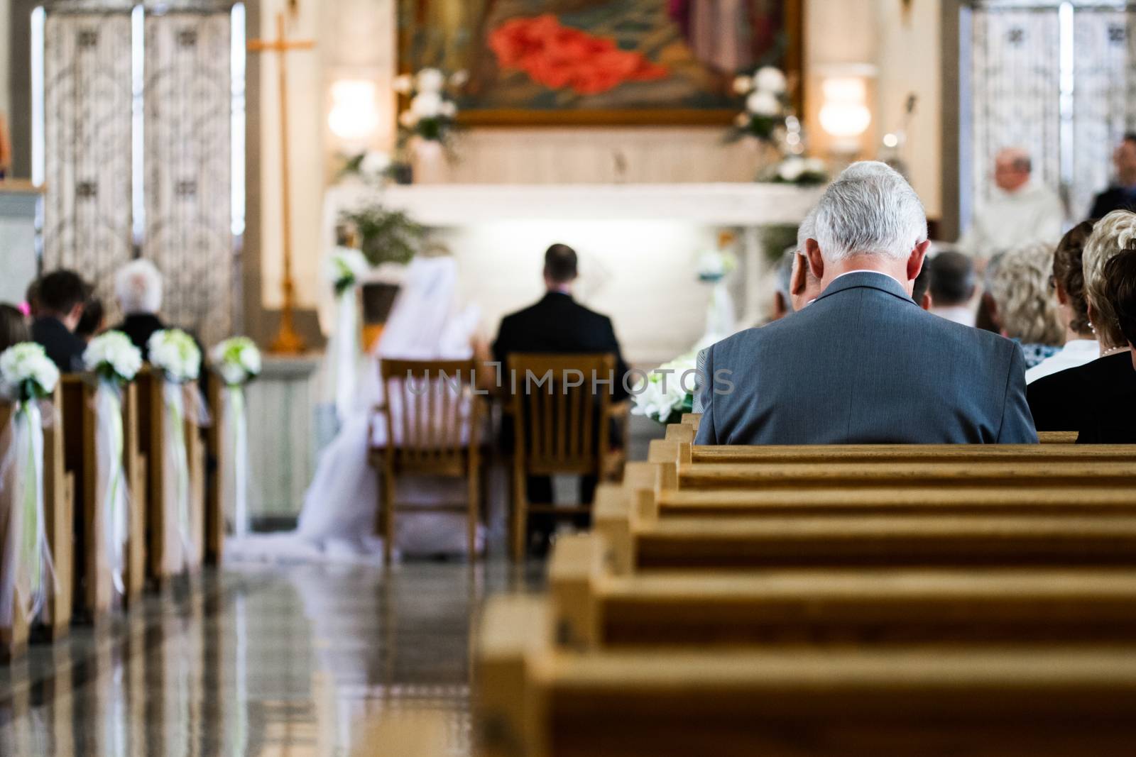 Wedding Ceremony inside a Church with Blurry Couple in Background