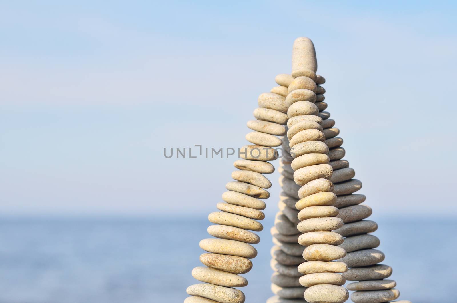 Pyramidal group of small pebbles in the balance on the seashore