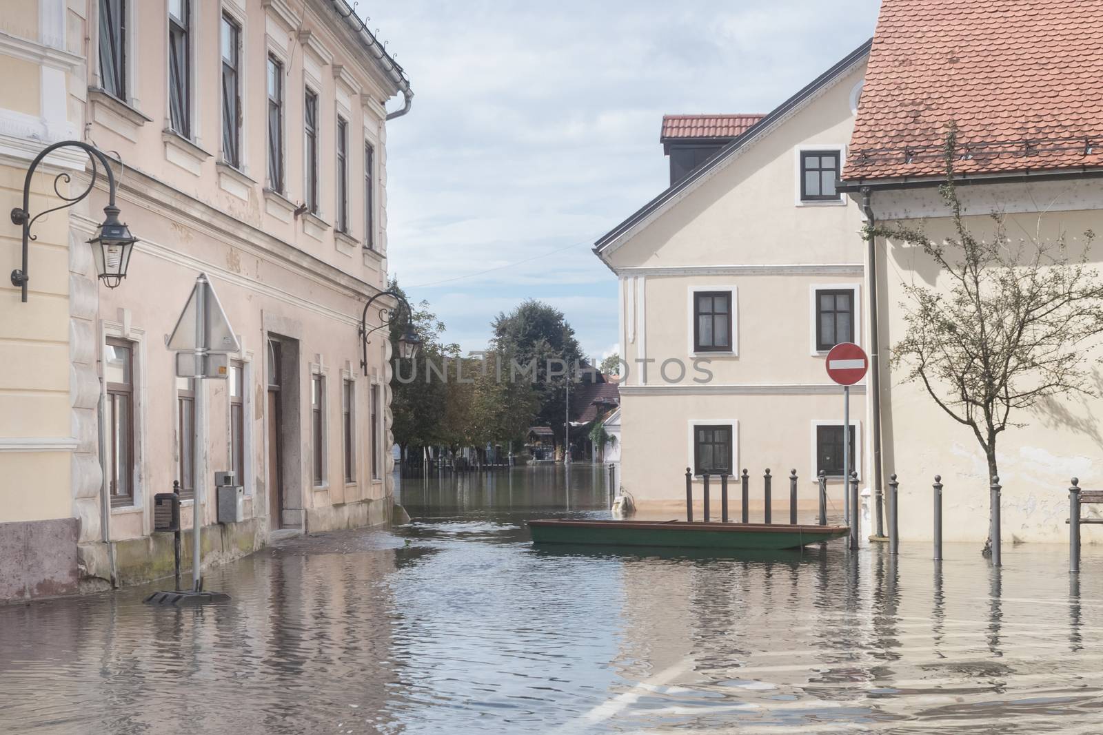 Rural village houses in floodwater. Road with the river overflown with the residents in their homes. River Krka floods and flooding the streets. Natural disaster in Kostanjevica, Slovenia.  