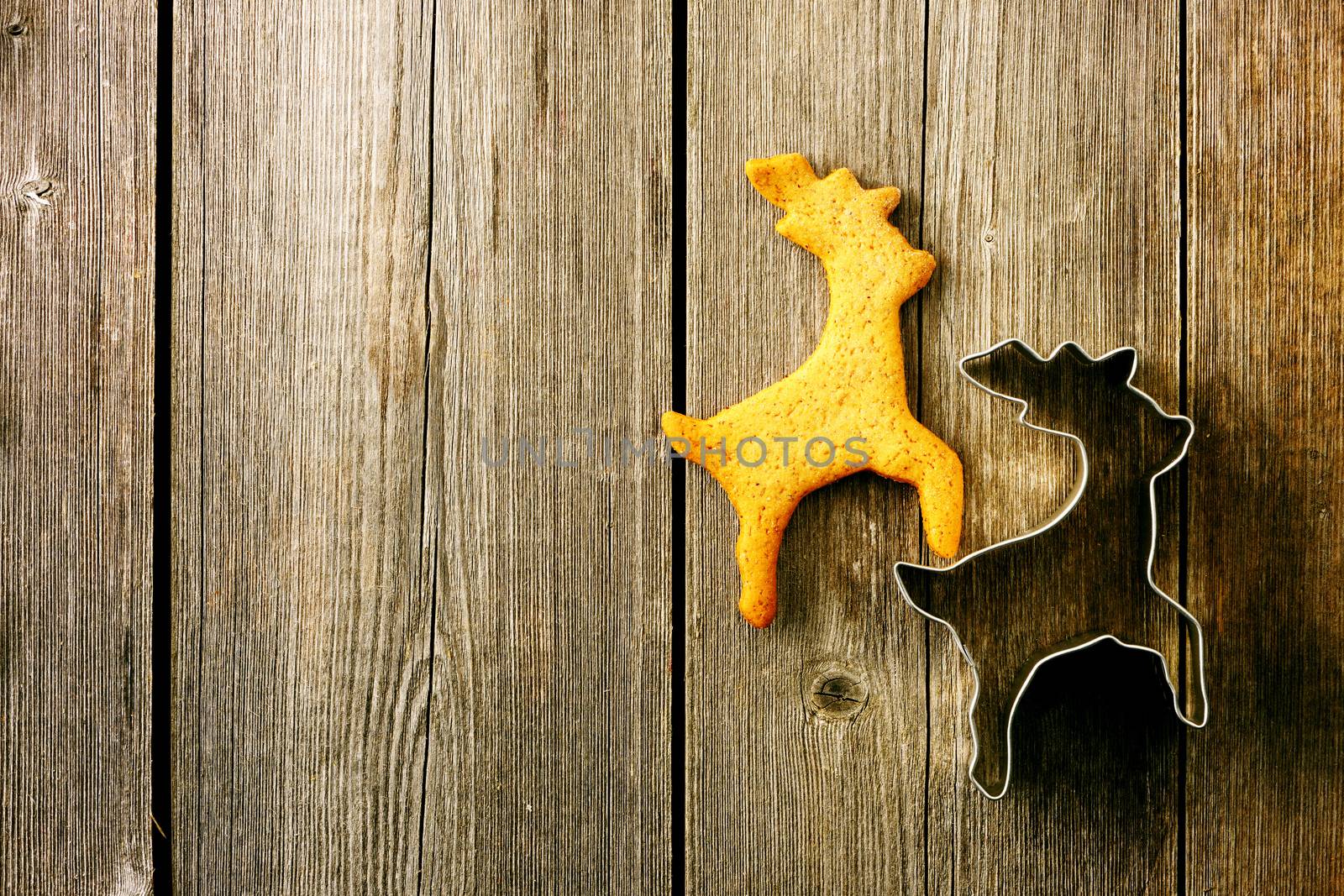 Christmas homemade gingerbread deer over wooden table