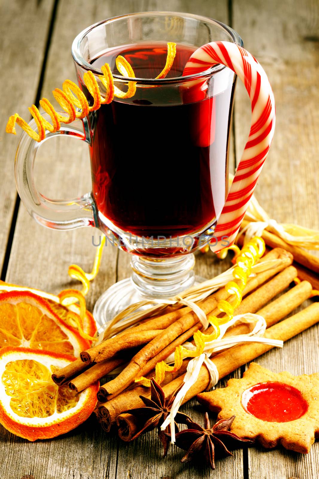 Glass of red mulled wine on wooden table