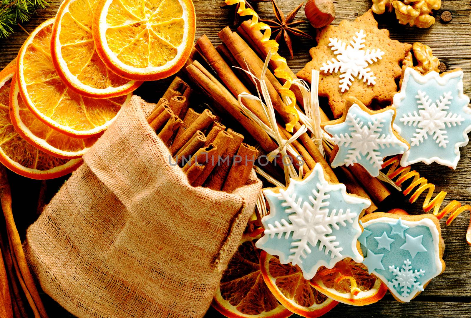 Christmas homemade gingerbread cookie and spices over wooden table