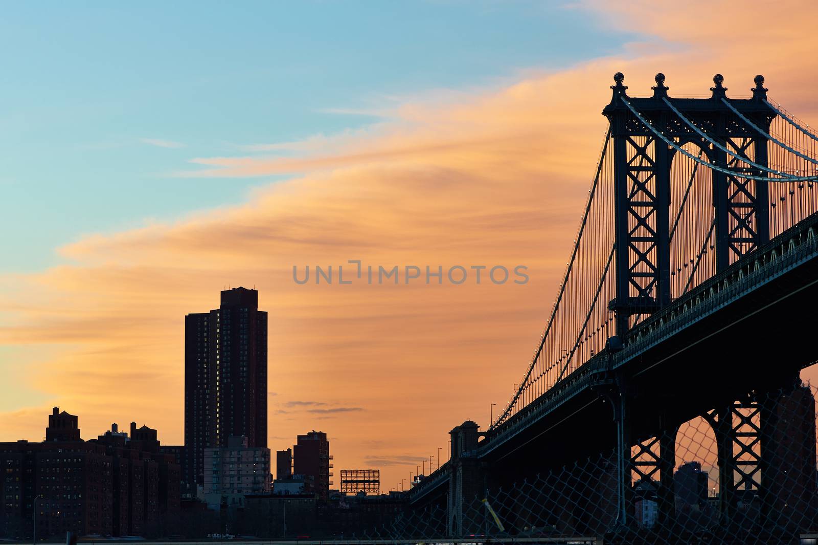 Manhattan Bridge and skyline silhouette view from Brooklyn in New York City at sunset