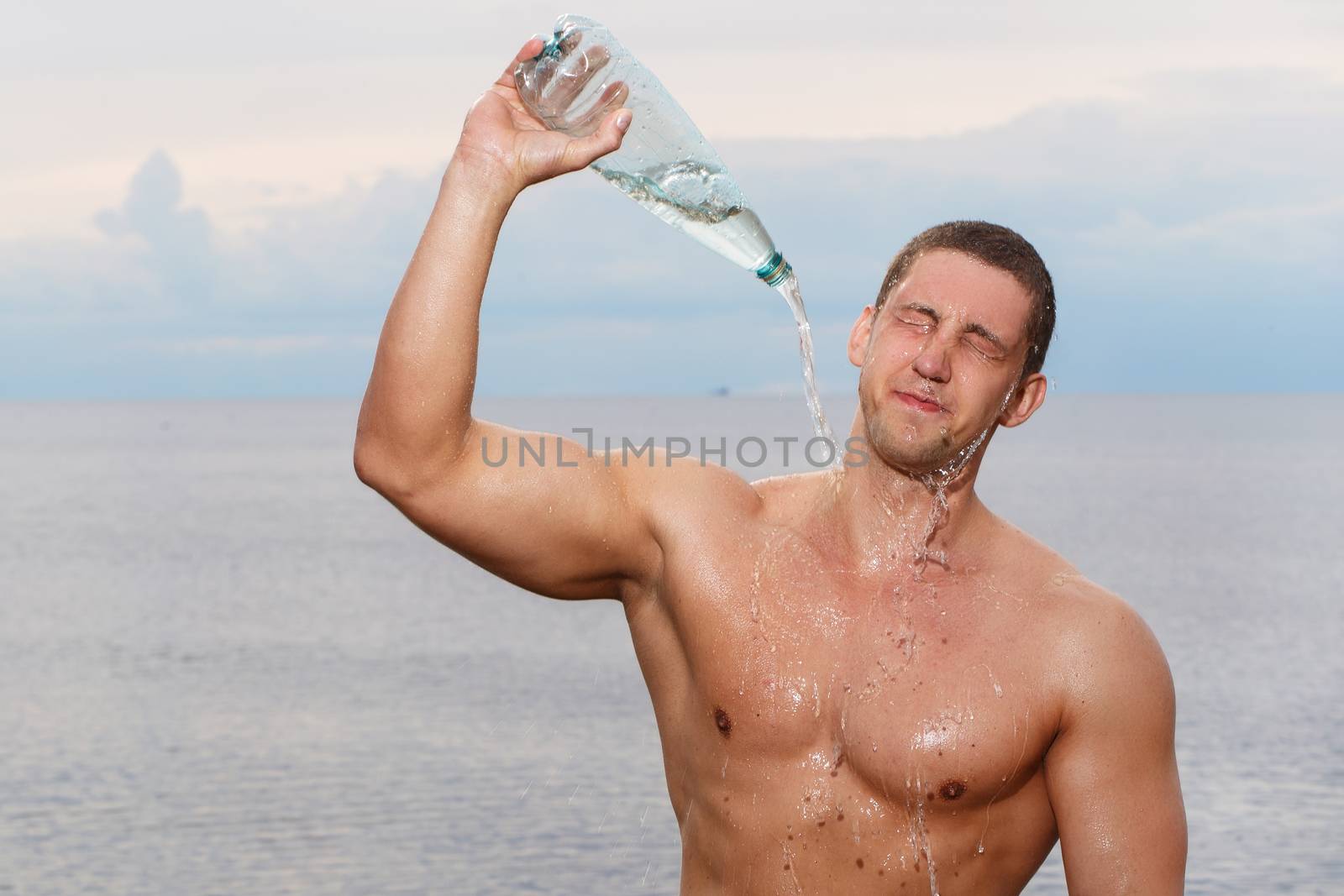 Sport, fitness. Bodybuilder with sexy body on the beach