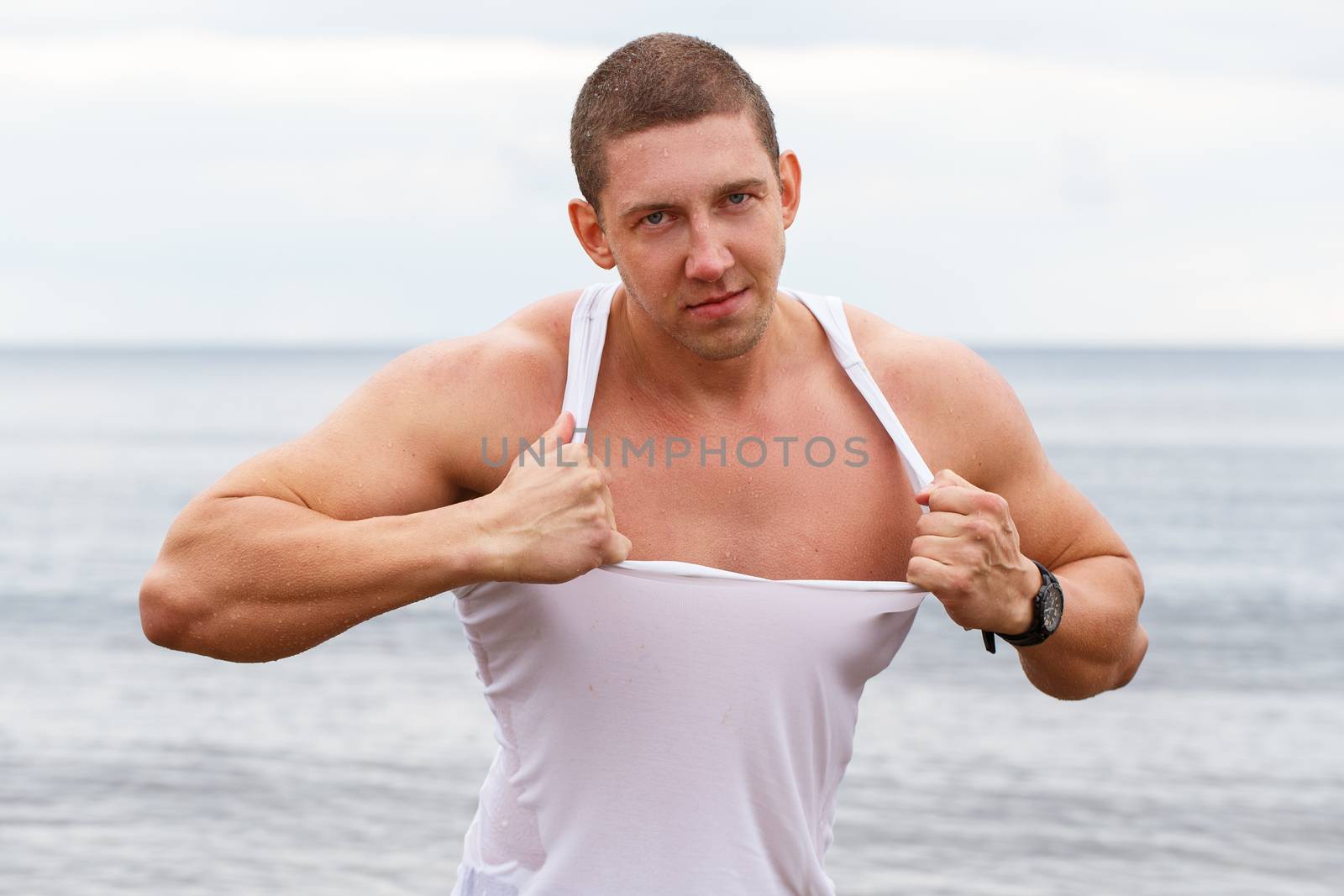 Sport, fitness. Bodybuilder in torn shirt