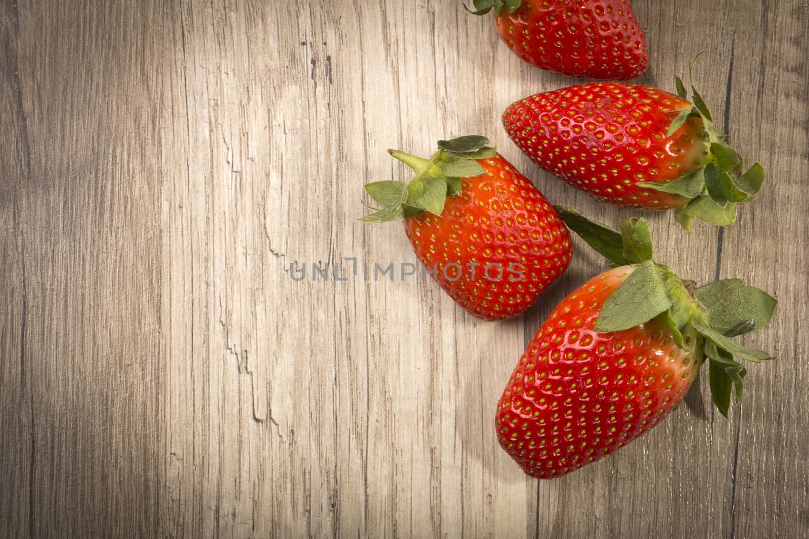 Strawberries on wooden background with copy space