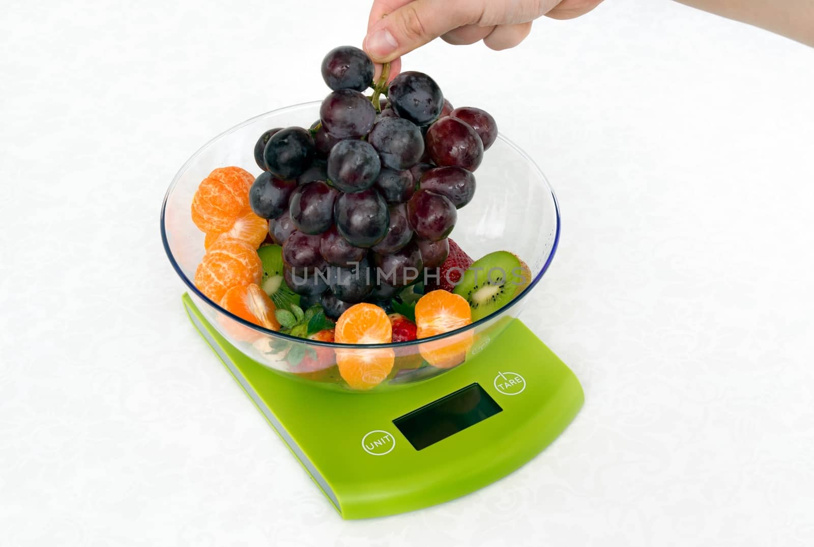 Lots of fruit on the kitchen scale in a modern kitchen by simpson33